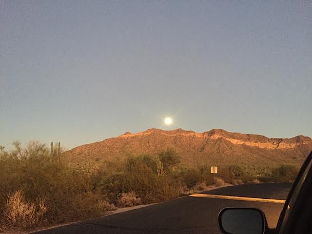 The moon coming up over the mountain at the range