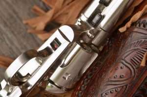One of few noteworthy physical differences between a .45 Colt SAA and the Umarex Colt SAA airgun is the addition of a manual safety which is discretely added just forward of the triggerguard. Also note the authentic-looking transverse cylinder pin release.