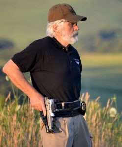 The rig is worn so that the gun can be cleanly drawn from the holster with a slight forward and upward movement of the hand to clear the triggerguard lock and nosepiece that retain the gun in the holster.