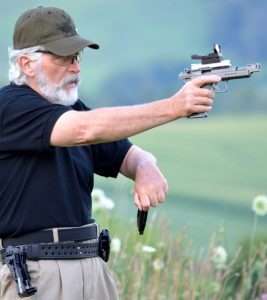 The magazine is withdrawn from the pouch and the hand begins a swift rotation upward to position it for reloading…