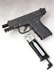 The drop free M22 magazines hold the CO2 (shown being seating into the channel with the combination tool) and 18 steel BBs.