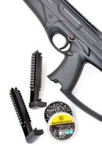 Like a 21st Century Uzi, the CX4 Storm, (cartridge-firing and airgun models), load their magazines into the pistol grip. The Umarex uses a 30-round, belt-fed rotary magazine.