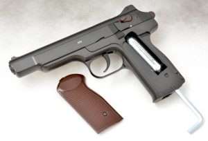 The CO2 cartridge is loaded into the left side of the grip frame.