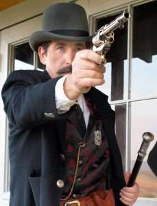 Bat Masterson (portrayed here by the author from Guns of the Old West) wore his Colt cross draw style, butt forward and covered, making it almost impossible for anyone to disarm him from behind. It has also been written that he carried two guns, and in some instances he did when heading up a posse or on the open plains, but in town where most everything happened at close range, it was the shorter barreled Colt carried cross draw that Bat preferred over any other.