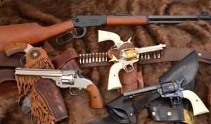 The Guns that Won the West included single action revolvers from Colt and Smith & Wesson, and Winchester lever action rifles. Modern CO2-powered Old West guns not only provide the look but the feel of the original 19th century designs. Pictures at top the Umarex lever action rifle, far left two nickel plated Schofield revolvers from Bear River, center two hand engraved Umarex Colt Peacemakers with a Western Justice holster and cartridge belt, and at lower right the standard blued model Umarex Colt SAA with a Cavalry holster and belt by John Bianchi Frontier Gunleather. 