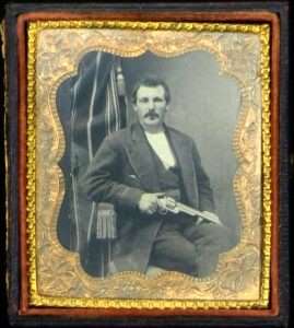 By the early 1870s S&W had become the first American armsmaker to offer a large caliber, cartridge-loading revolver. This S&W Second Model American with nickel plated finish and 8-inch barrel is pictured in this daguerreotype portrait of a man holding a nickel plated S&W American. (Mike Clark Collection/Collectors Firearms)