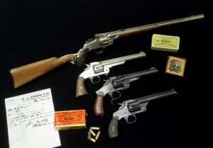 Smith & Wesson was second only to Colt’s when it came to the popularity of its innovative handguns in the 1870s. Pictured are a variety of models, at top, S&W’s Model 320 revolving rifle with detachable should stock. This example has a 20-inch barrel is nickel plated and in the standard .320 S&W caliber. The second gun is a Second Model American nickel plated, with an 8-inch bbl and chambered in .44 American. The third gun is a rare Ludwig Loewe Russian Model in .44 Russian with 6-1/2 inch barrel. The bottom example is a Number 3 Target chambered .32-44 caliber with a 6-1/2 inch barrel. (Mike Clark Collection/Collectors Firearms)