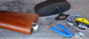 The CO2 is inserted into the buttstock and threaded into the CO2 chamber. To tighten it down the included wrench fits around the cylinder for the final turn to pierce the CO2 cartridge. The buttplate is replaced and the rifle is ready to load.