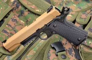 The Umarex Colt M45 CQBP has deeply milled black G10-style plastic grips. The left panel removed to allow inserting the CO2 into the grip frame. Also note the skeletonized Delta-style knurled hammer.