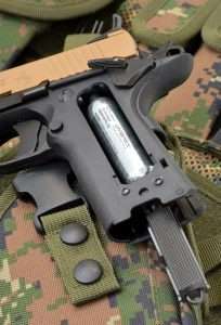 The flat mainspring housing slides off and had a correct hex head fitting on the top that is used to tighten the CO2 seating screw built into the grip frame. This eliminates the need for a separate tool to seat the CO2, which is necessary for the Colt Commander version.