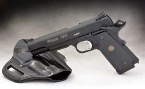 The CO2-powered Sig Sauer has a skeletonized aluminum alloy target trigger with vertically serrated shoe and over travel adjustment. The diamond checkered rubber Tac Master grips give the pistol a secure, tactile hold with the wraparound frontstrap panel. It is shown with a Galco Combat Master belt holster for the Sig Sauer P226. The 1911 rail gun also fits this rig as well as several other offered by Galco.