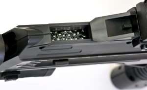 The BB reservoir is underneath the front sight, which slides back to allow loading.