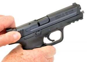 Here the .40 S&W model’s barrel breechblock tilts down as the slide moves back…