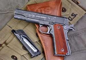 The John Wayne signature and name on the left side of the slide and 1911 Commemorative distinguish this model from the previous limited edition WWII commemorative 1911A1 model. (Holster and web magazine belt courtesy World War Supply)
