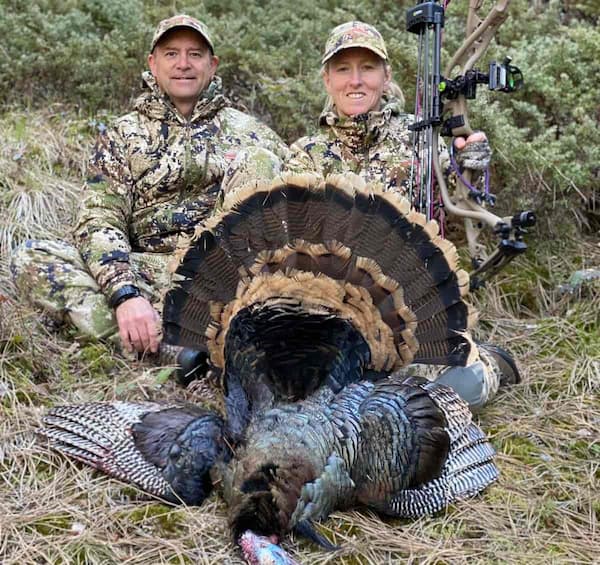 The author and his wife with a Merriam’s turkey taken with archery tackle.