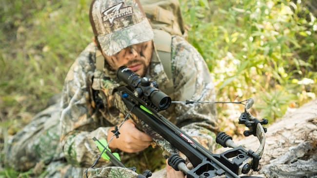 hunter with excaliber crossbow stalking prey 