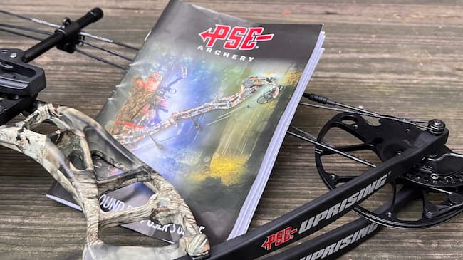 PSE archery maintenance guide beside a PSE bow.