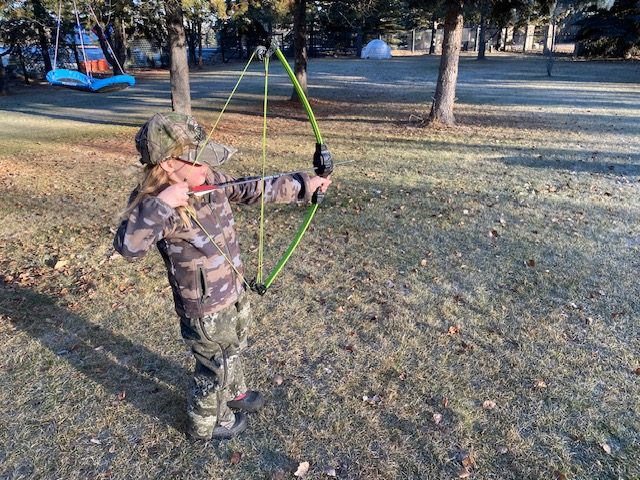 youth archer practicing with a compound bow.