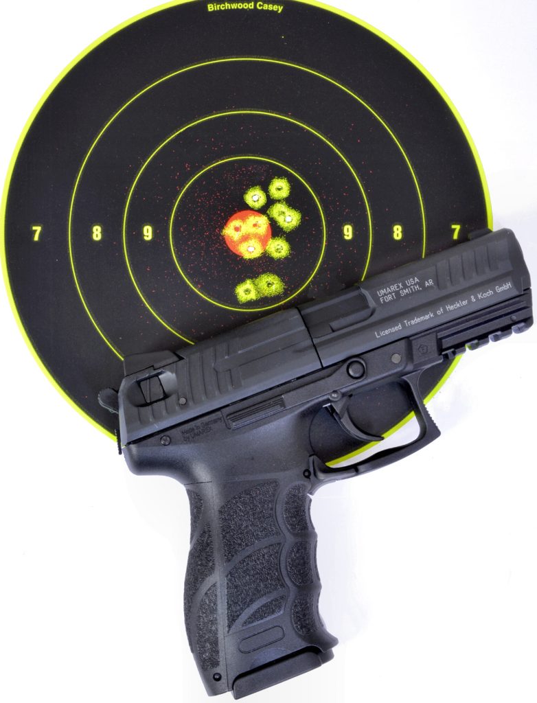 Pistol laying on target showing the groups made during the shooting session.