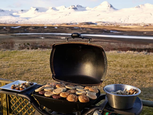 Enjoying the harvest. BBQ grill covered in burger buns as they toast.