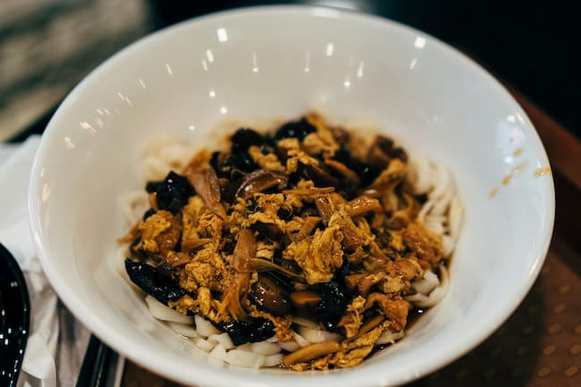 bowl of cooked meat over pasta