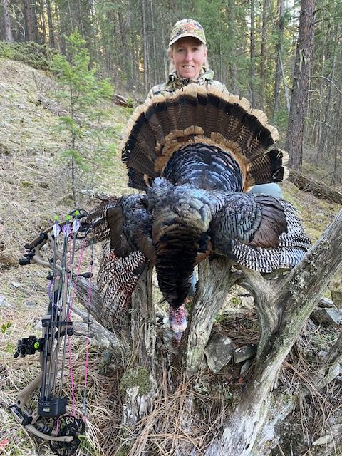 Hunter, Heather Wilson, holding up the turkey she harvested with her bow. 
