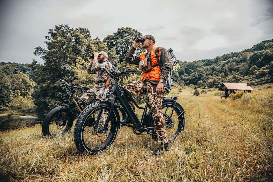 two hunters riding ebikes, looking for quarry