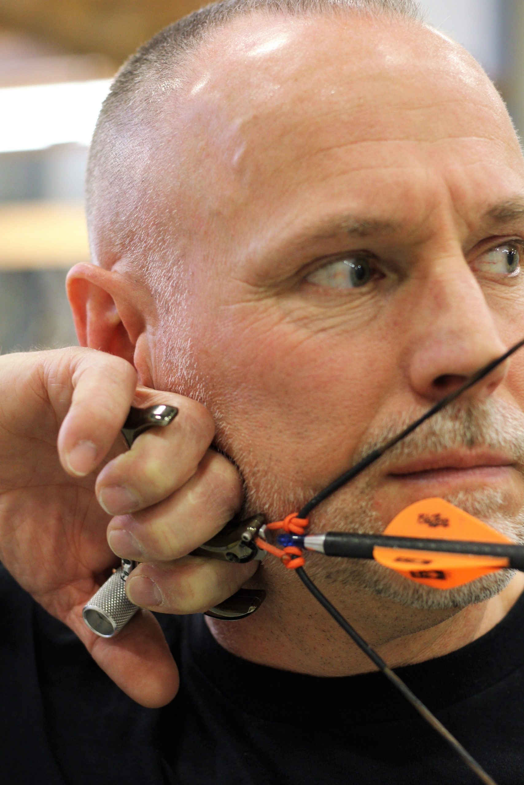 archer using a release to draw and hold bow string