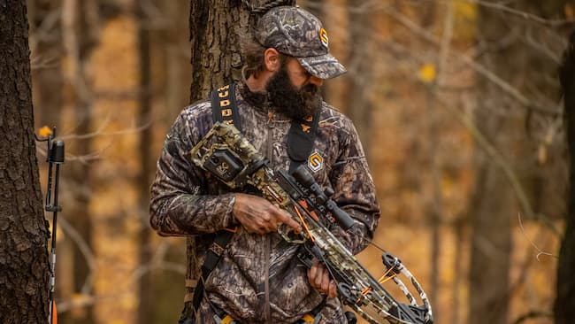 Hunter with crossbow equipped with ACUdraw cocking device.
