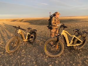 author's hunting partner with 2 ebikes set on the trail