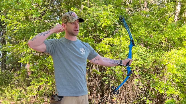 teacher showing technique to shoot the Genesis Youth bow