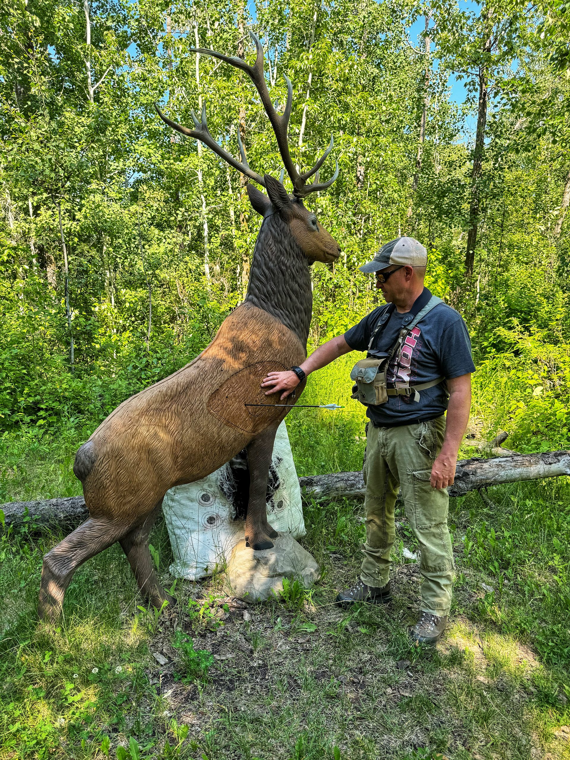 Kevin Wilson standing beside a buck 3D target showing arrow penetration.