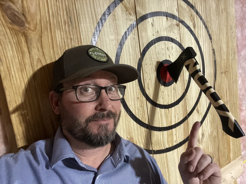 author with woox axe in bullseye of diy target