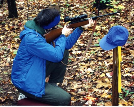 Field target shooter in the kneeling position